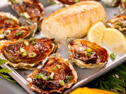 a serving tray with small oysters on the half shell that have been roasted with Hama Hama Oyster Company's house made chipotle bourbon butter